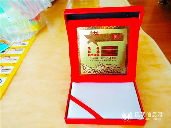 秦建云获得的“寻找国庆人”纪念品。记者江枫 摄