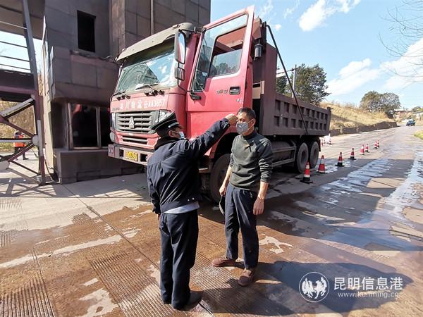 16.安宁市金方街道设在昆钢北大门的疫情防控检查点上，昆钢后勤保障部杨永前细致检查过往车辆，为每一位途经的人员测量体温。刘家荣 摄